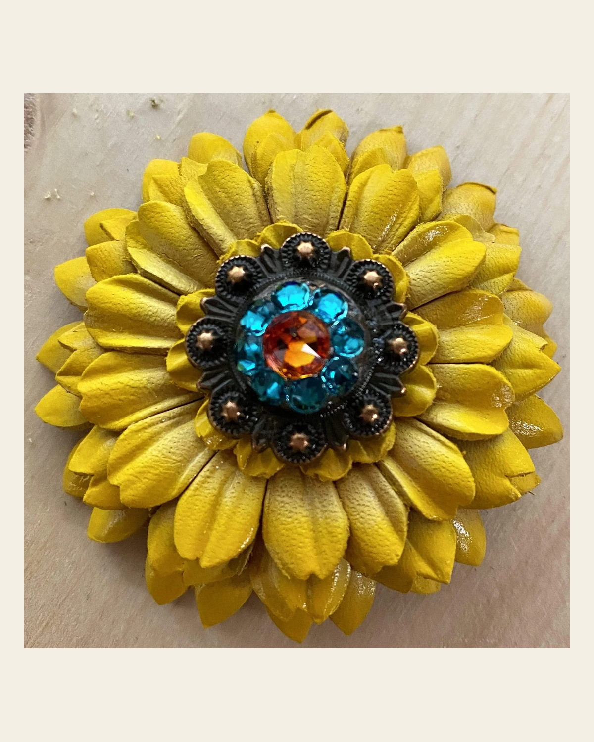 Sunflower With Copper Fire Opal & Teal 1" Concho on a warm cream background
