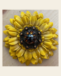 Sunflower With Copper Jet & Topaz 1" Concho on a warm cream background