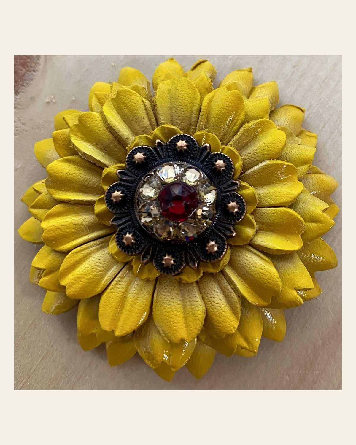Sunflower With Copper Ruby & Champagne 1" Concho on a warm cream background