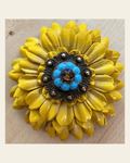 Sunflower with Copper Turquoise & Topaz 1" Concho on a warm cream background