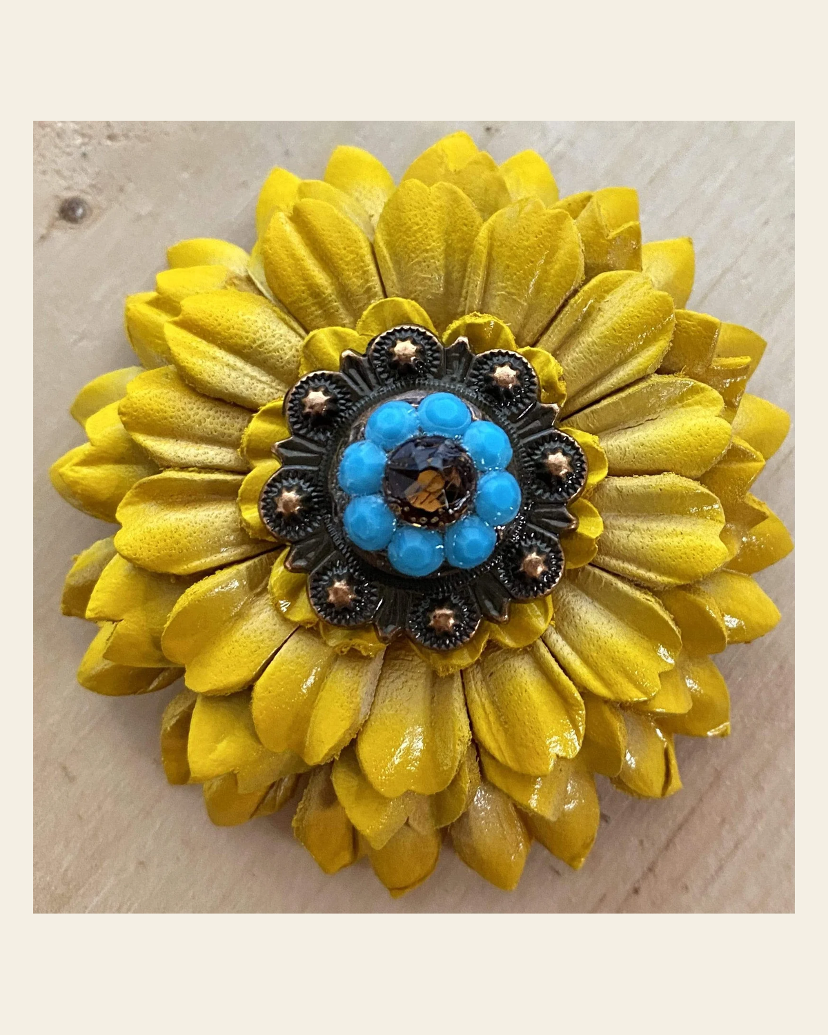 Sunflower with Copper Turquoise & Topaz 1" Concho on a warm cream background