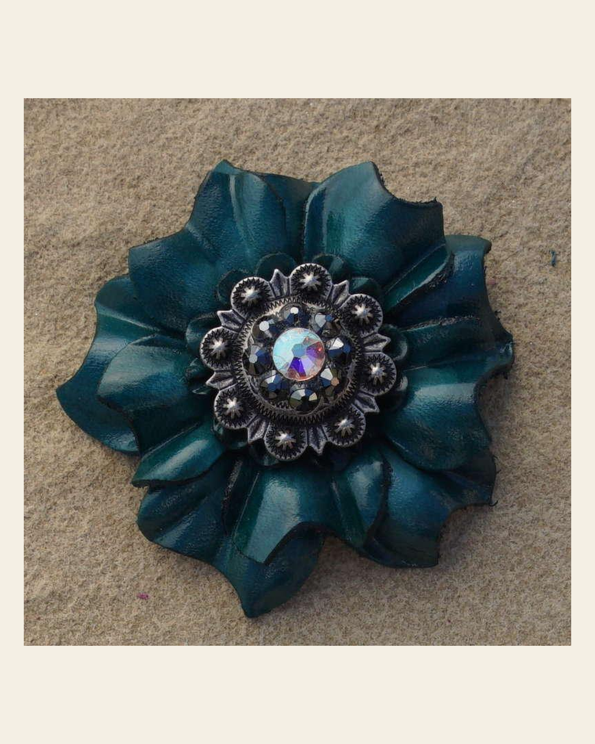 Teal Carnation Flower With Antique Silver Jet and AB 1" Concho on a warm cream background