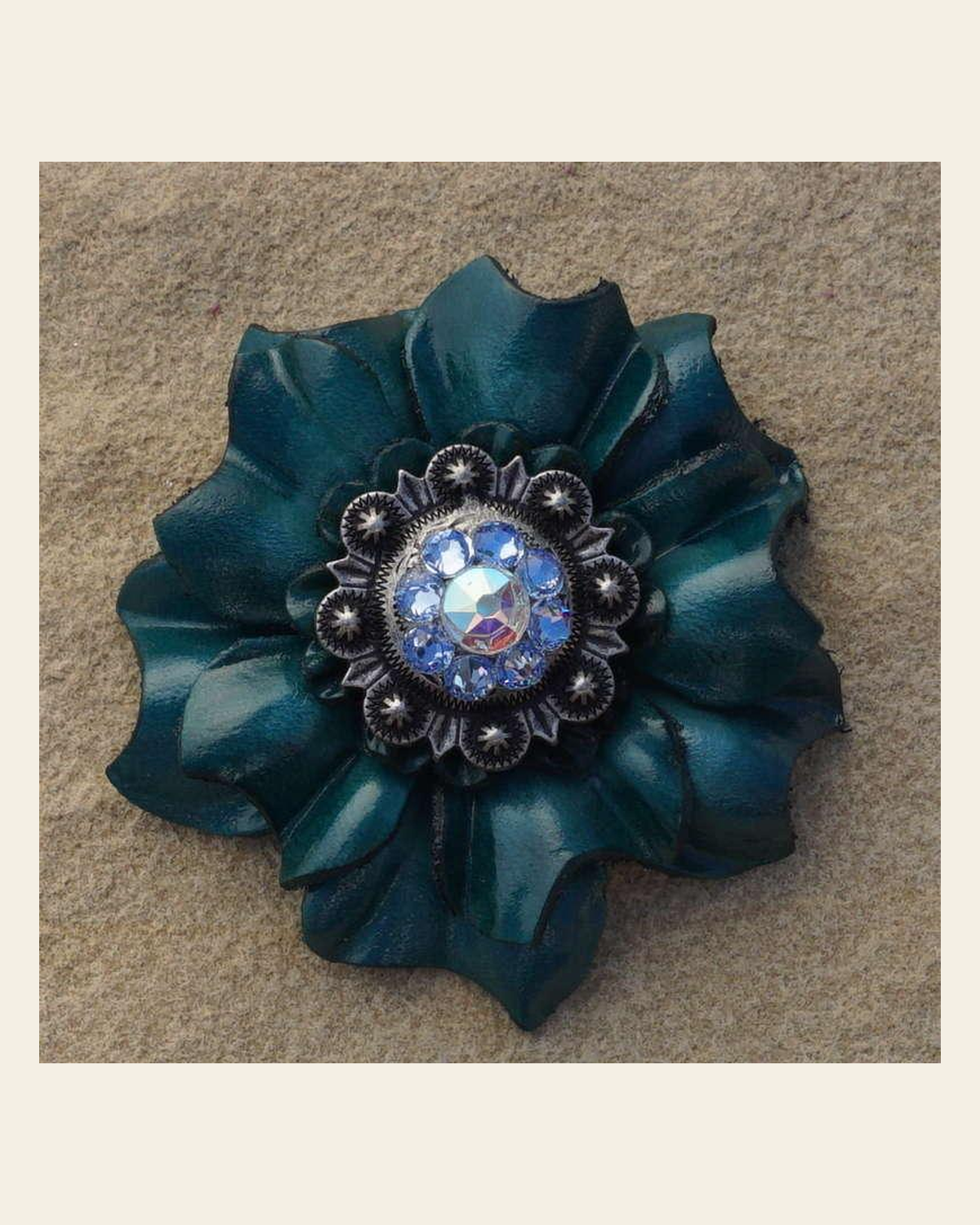 Teal Carnation Flower With Antique Silver Light Sapphire and AB 1" Concho on a warm cream background