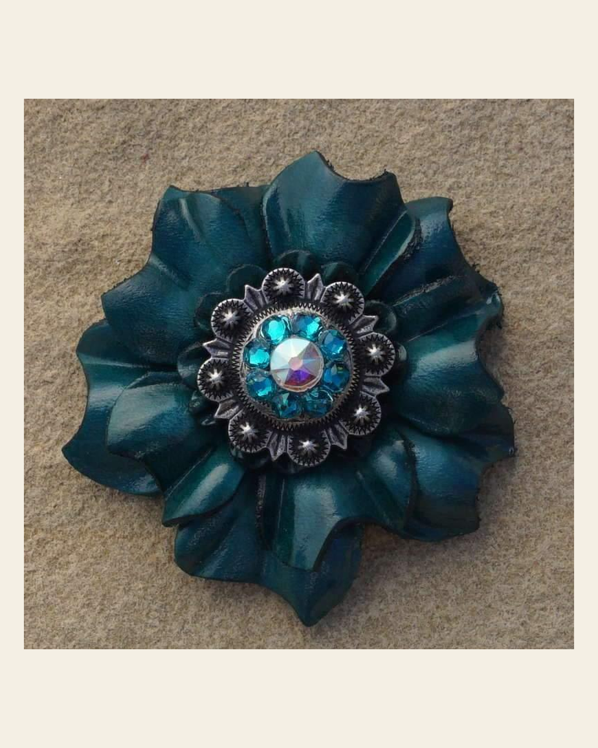 Teal Carnation Flower With Antique Silver Teal & AB 1" Concho on a warm cream background