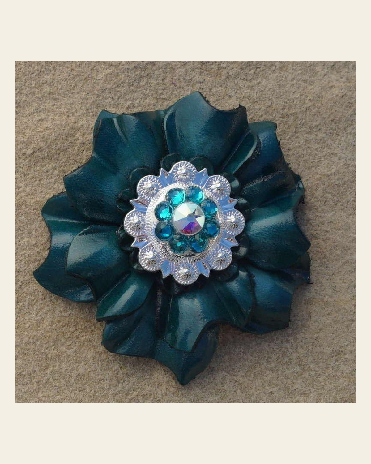 Teal Carnation Flower With Bright Silver Teal and AB 1" Concho on a warm cream background