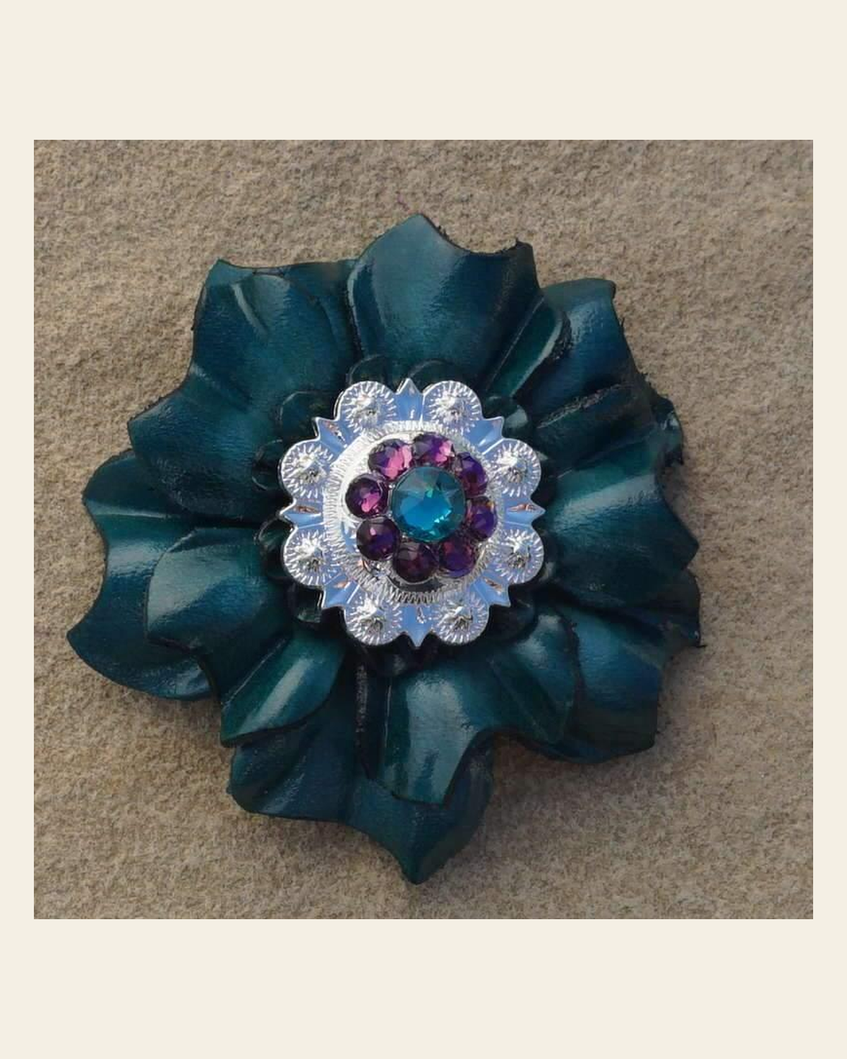 Teal Carnation Flower With Bright Silver Teal & Purple 1" Concho on a warm cream background