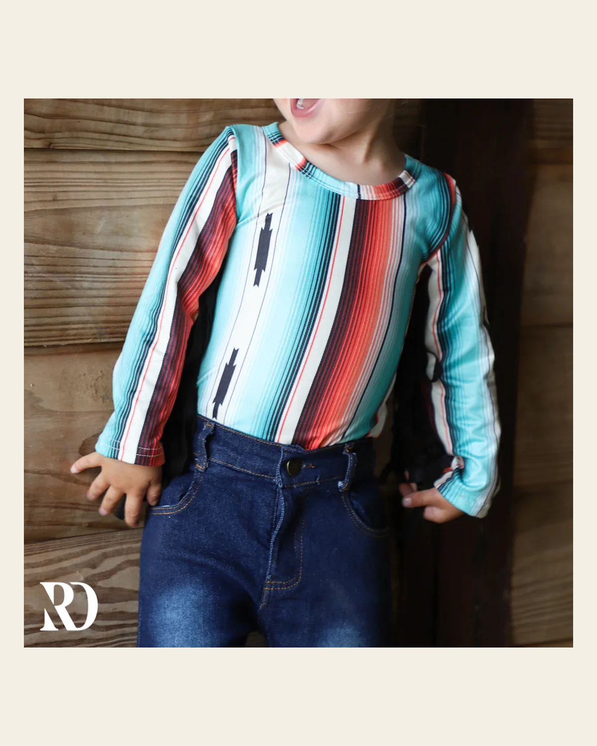Teal Serape Fringe Infant / Toddler Bodysuit on a warm cream background