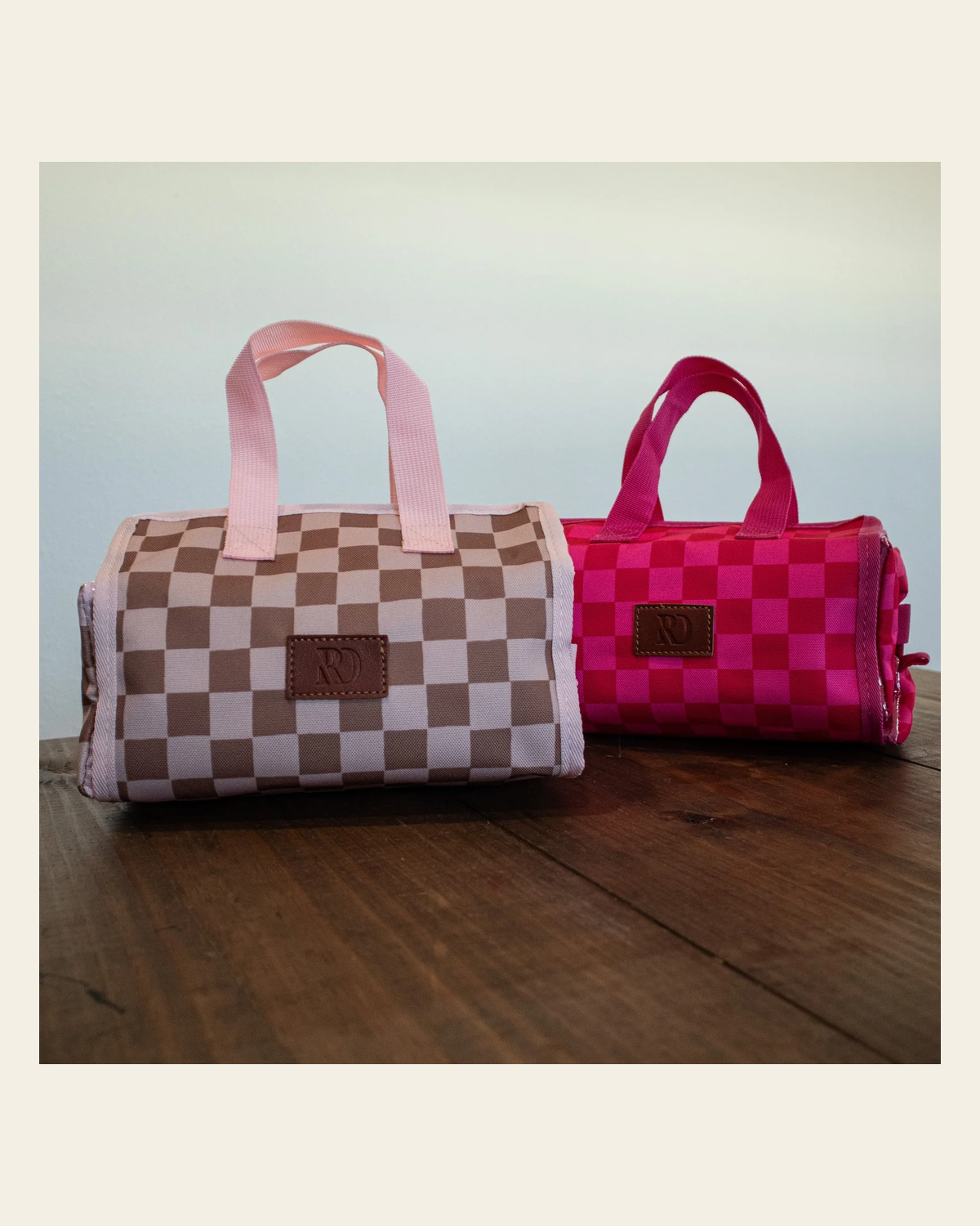 The Essential Toiletries Travel Bag on a warm cream background