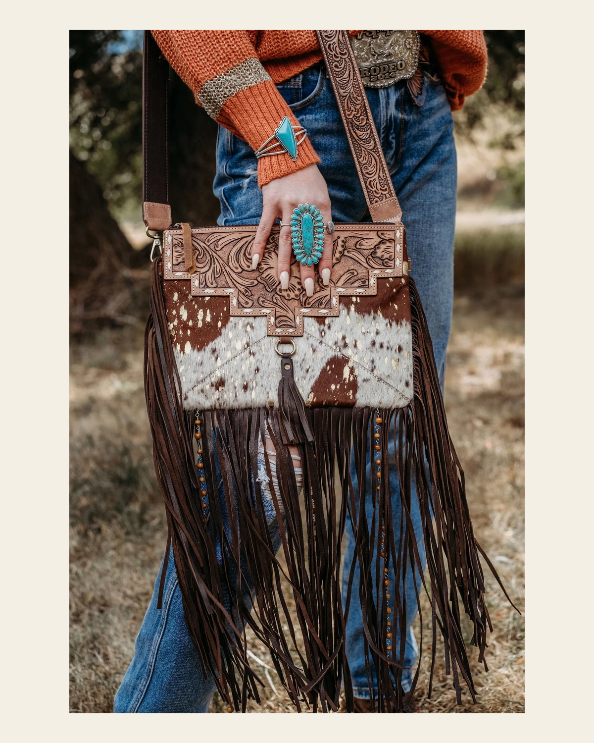 The Lancaster - Gold Splattered Cowhide | Purse on a warm cream background
