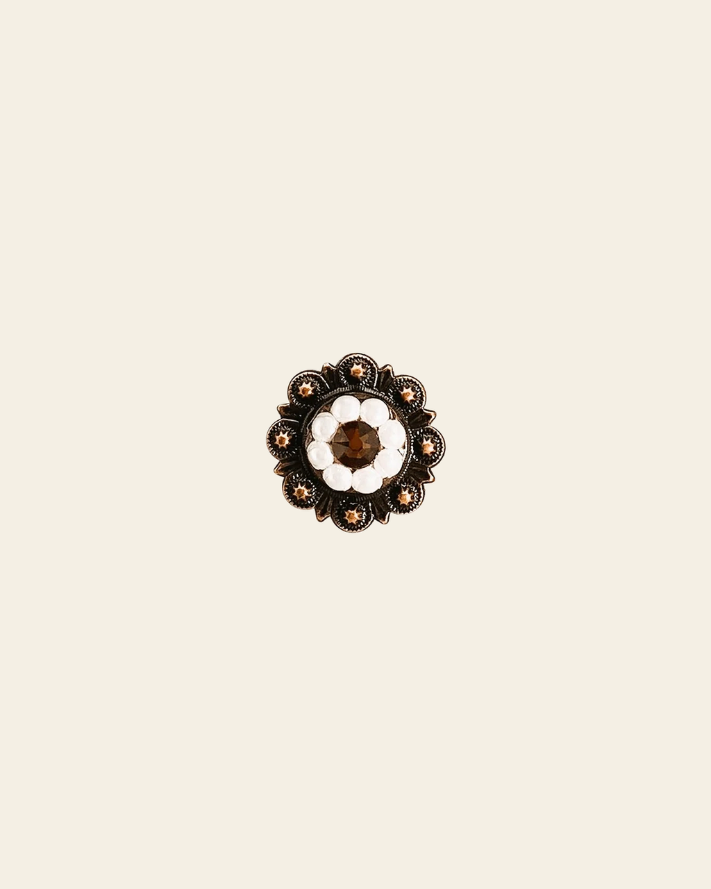Topaz & Pearl Copper 1" European Crystal Concho on a warm cream background