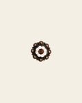 Topaz & Pearl Copper 1" European Crystal Concho on a warm cream background