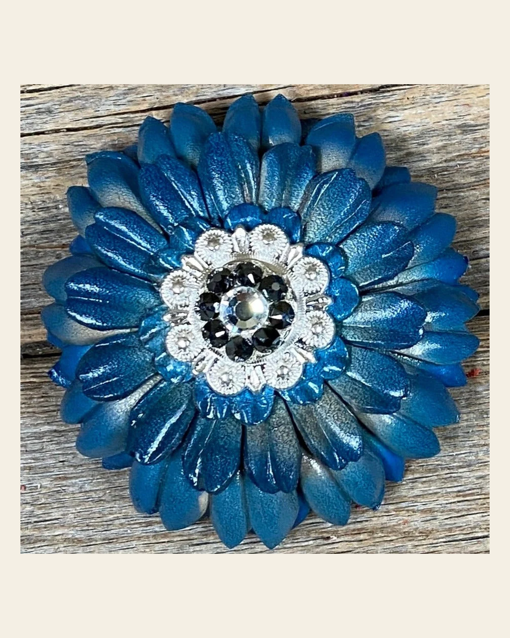 Turquoise Daisy Flower With Bright Silver Jet, Clear 1" Concho on a warm cream background