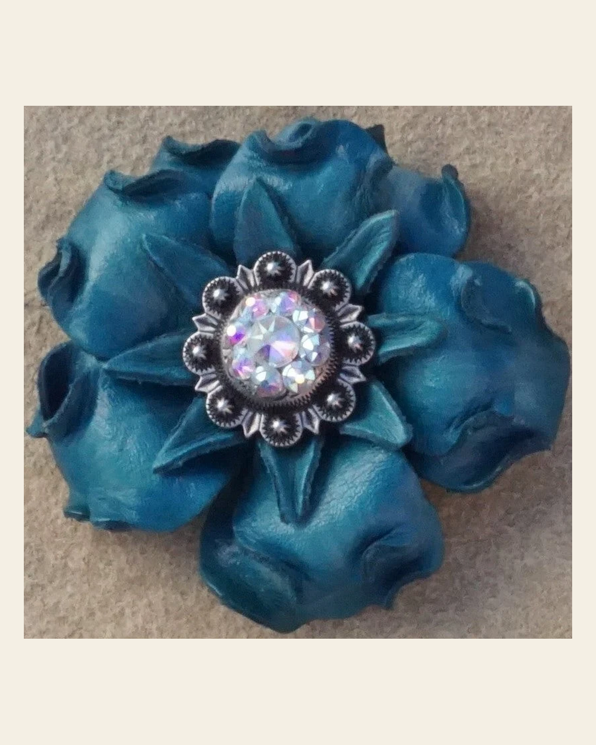Turquoise Gardenia Flower With Antique Silver AB 1" Concho on a warm cream background