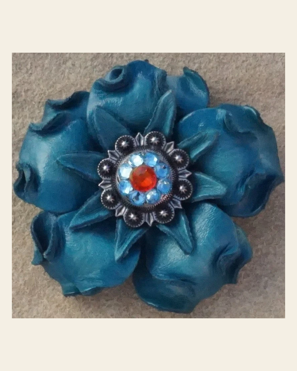 Turquoise Gardenia Flower With Antique Silver Fire Opal and Aqua 1" Concho on a warm cream background