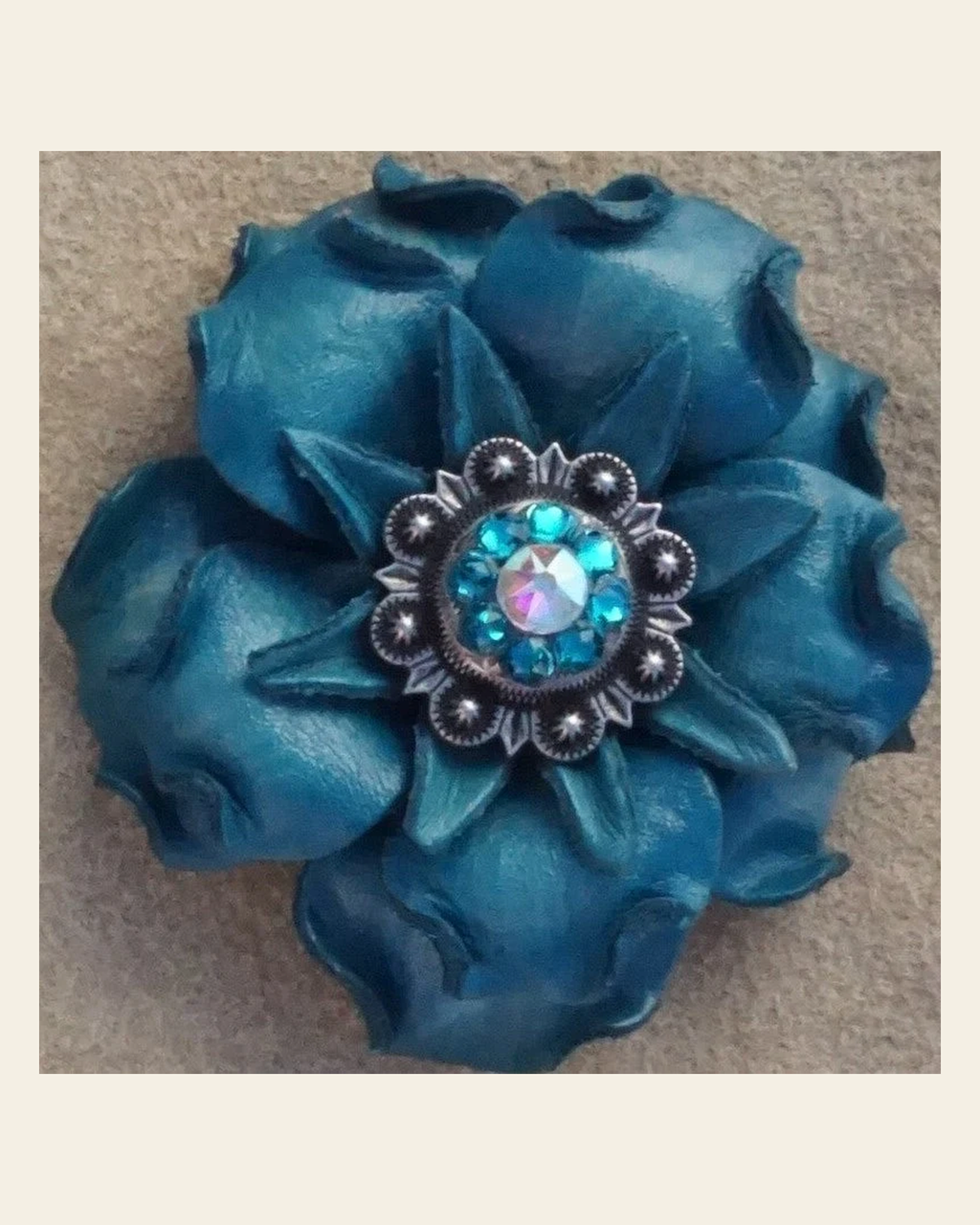Turquoise Gardenia Flower With Antique Silver Teal & AB 1" Concho on a warm cream background