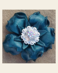Turquoise Gardenia Flower With Bright Silver AB 1" Concho on a warm cream background