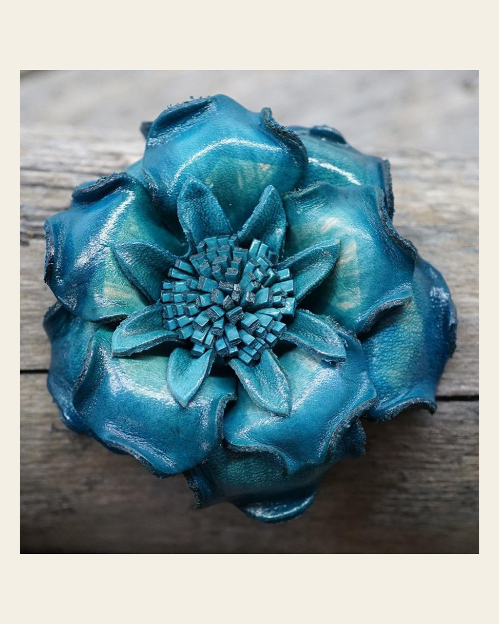 Turquoise Gardenia Leather Flower on a warm cream background