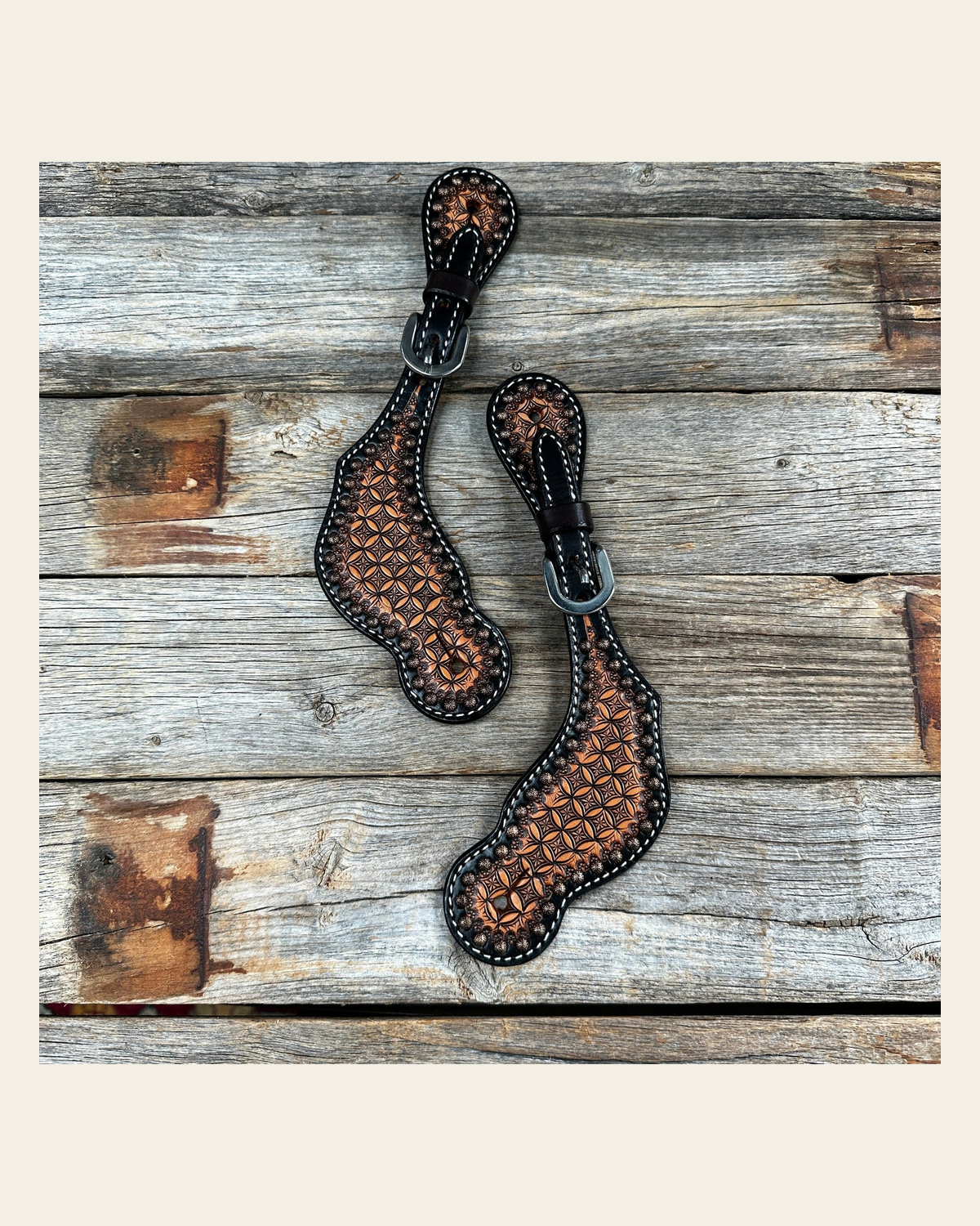 Two Tone Honeycomb Tooled Spur Straps on a warm cream background