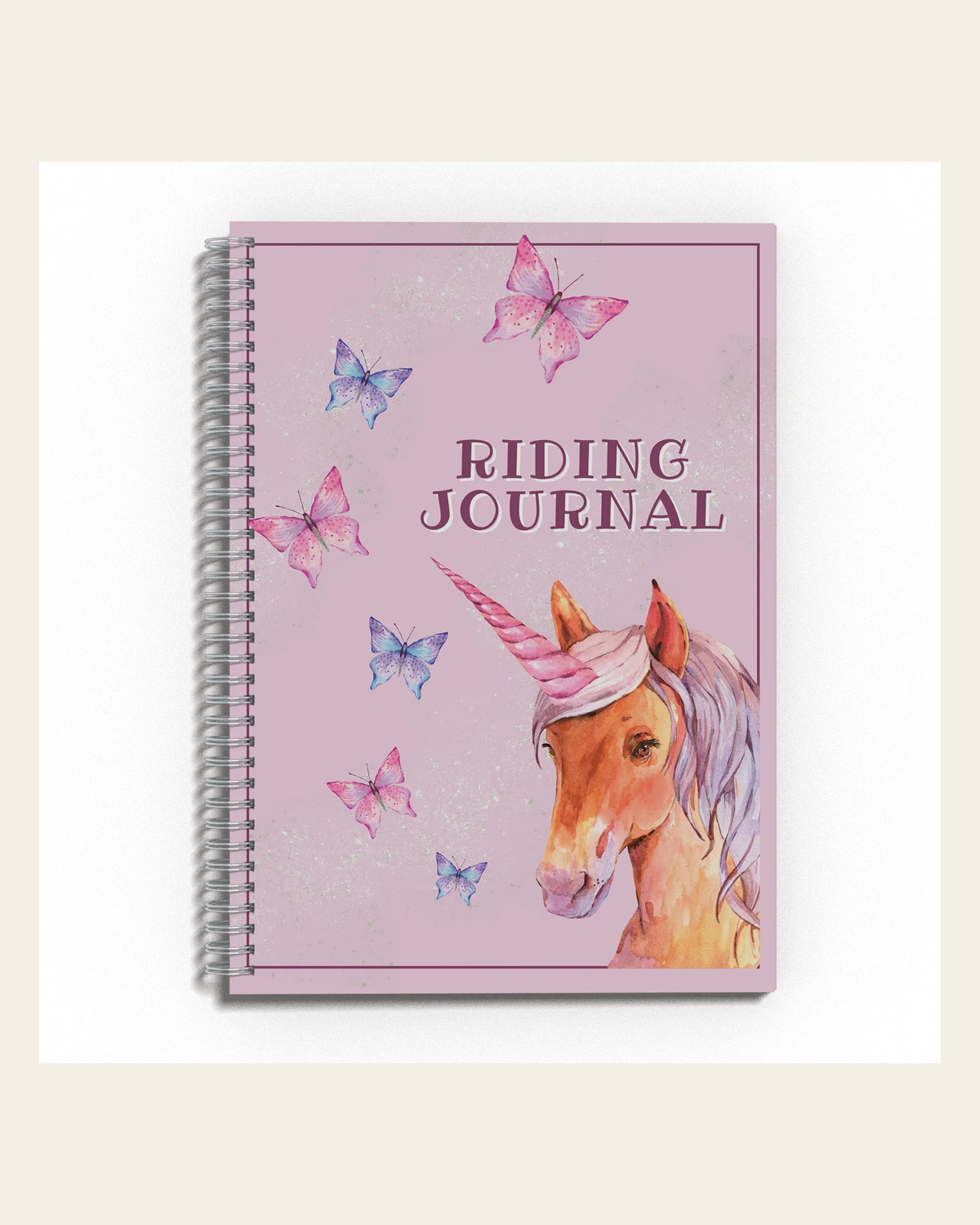 Unicorn Riding Journal on a warm cream background