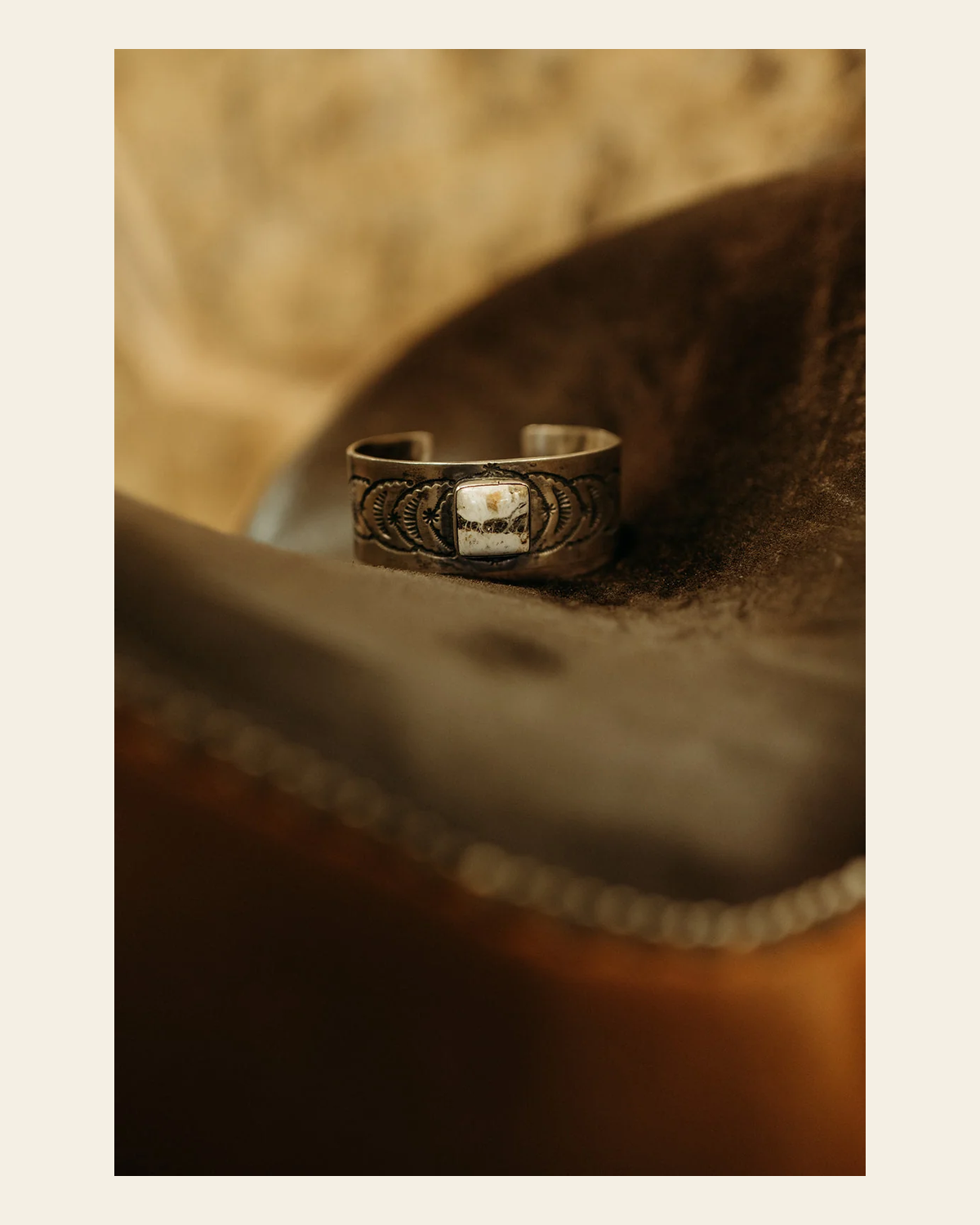 White Buffalo Turquoise Cuff By Thomas Yazzie on a warm cream background