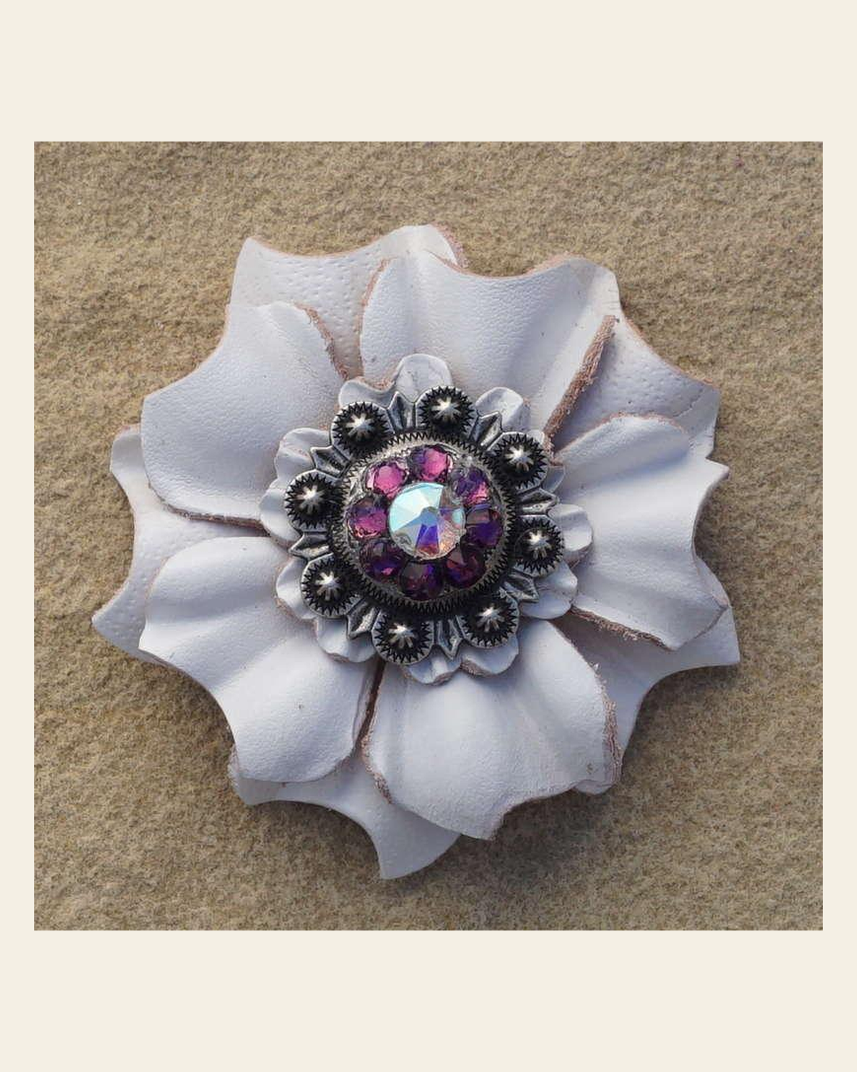 White Carnation Flower With Antique Silver Amethyst and AB 1" Concho on a warm cream background