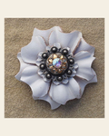 White Carnation Flower With Antique Silver Champagne and AB 1" Concho on a warm cream background