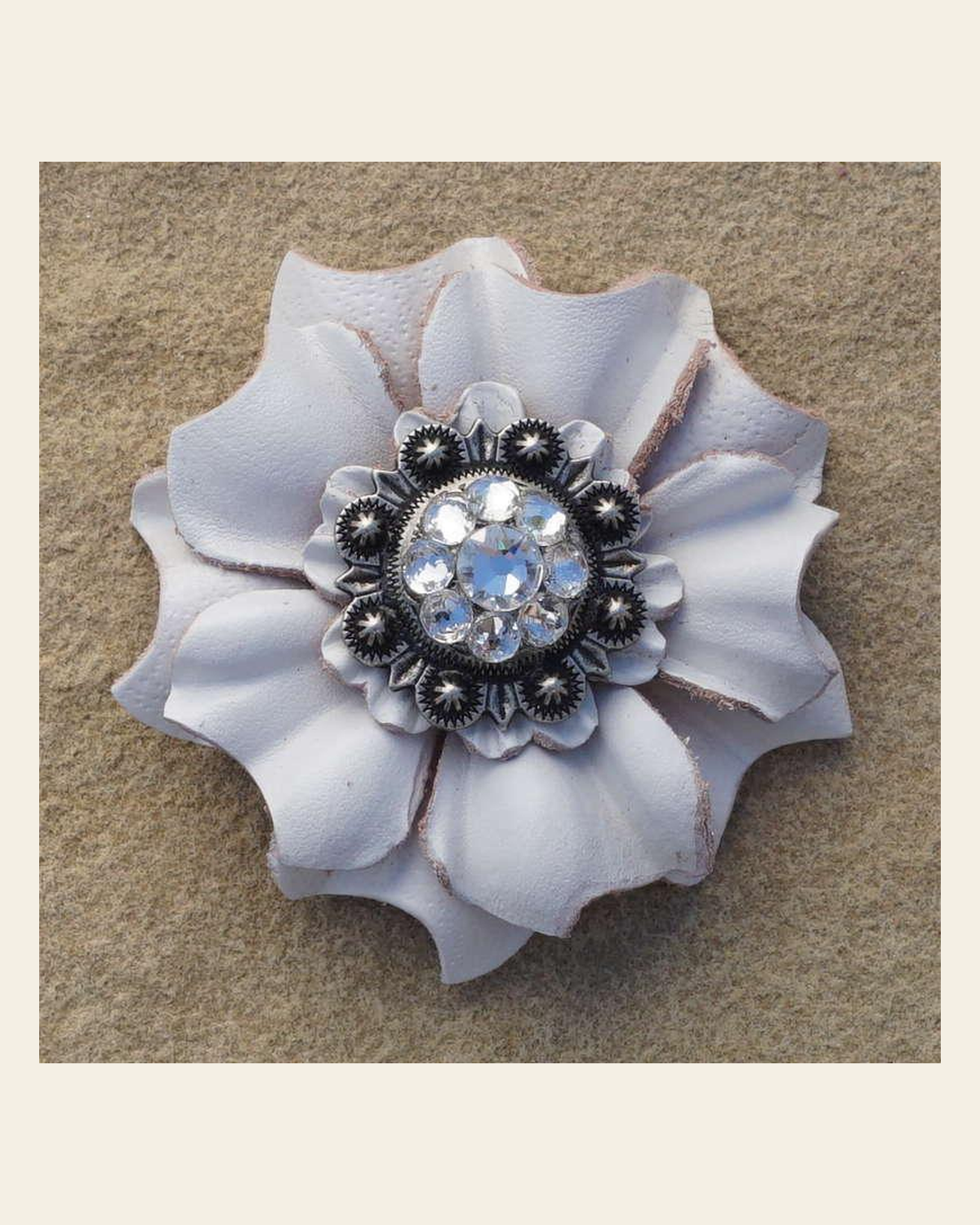 White Carnation Flower With Antique Silver Clear 1" Concho on a warm cream background