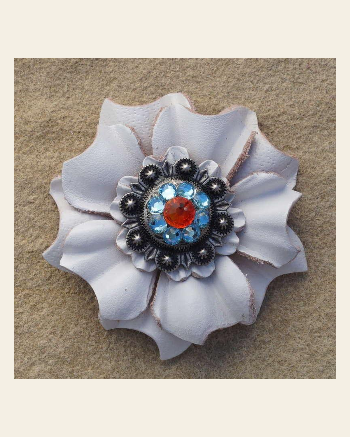 White Carnation Flower With Antique Silver Fire Opal and Aqua 1" Concho on a warm cream background