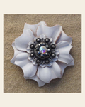 White Carnation Flower With Antique Silver Jet and AB 1" Concho on a warm cream background