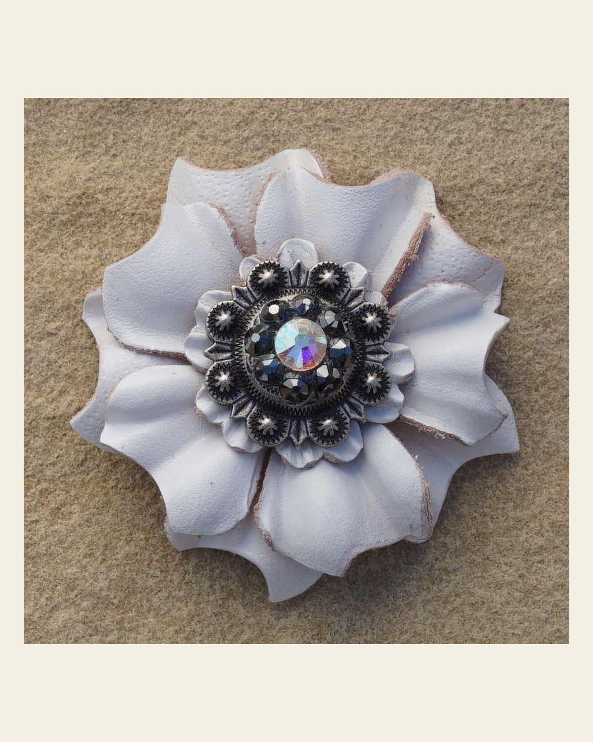 White Carnation Flower With Antique Silver Jet and AB 1" Concho on a warm cream background