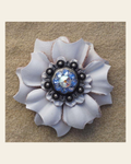 White Carnation Flower With Antique Silver Light Sapphire and AB 1" Concho on a warm cream background