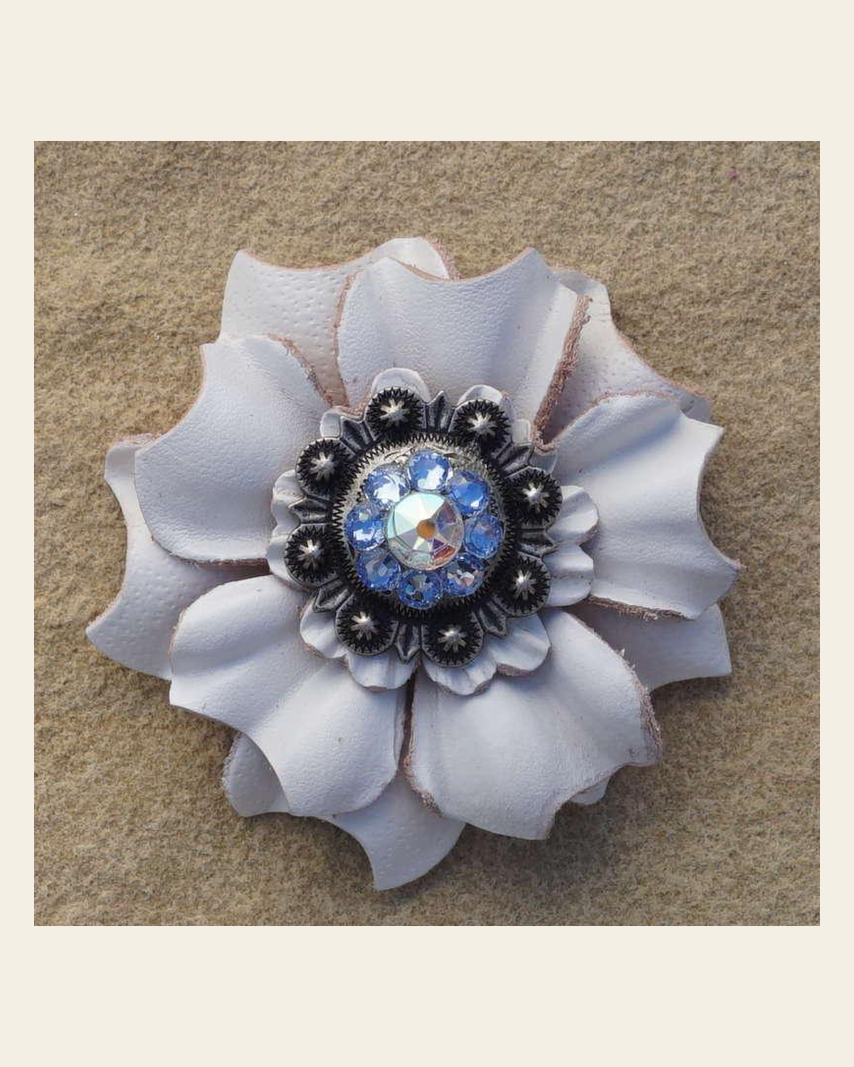 White Carnation Flower With Antique Silver Light Sapphire and AB 1" Concho on a warm cream background