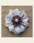 White Carnation Flower With Antique Silver Ruby and AB 1" Concho on a warm cream background