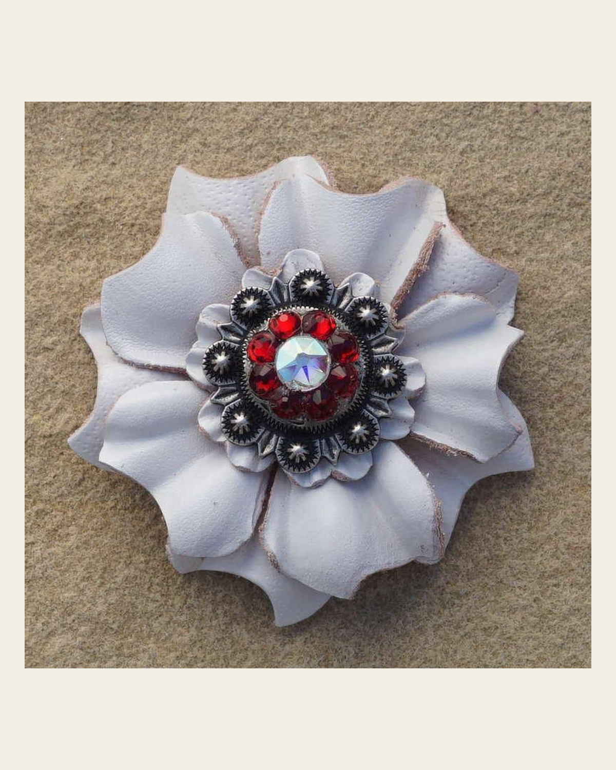 White Carnation Flower With Antique Silver Ruby and AB 1" Concho on a warm cream background
