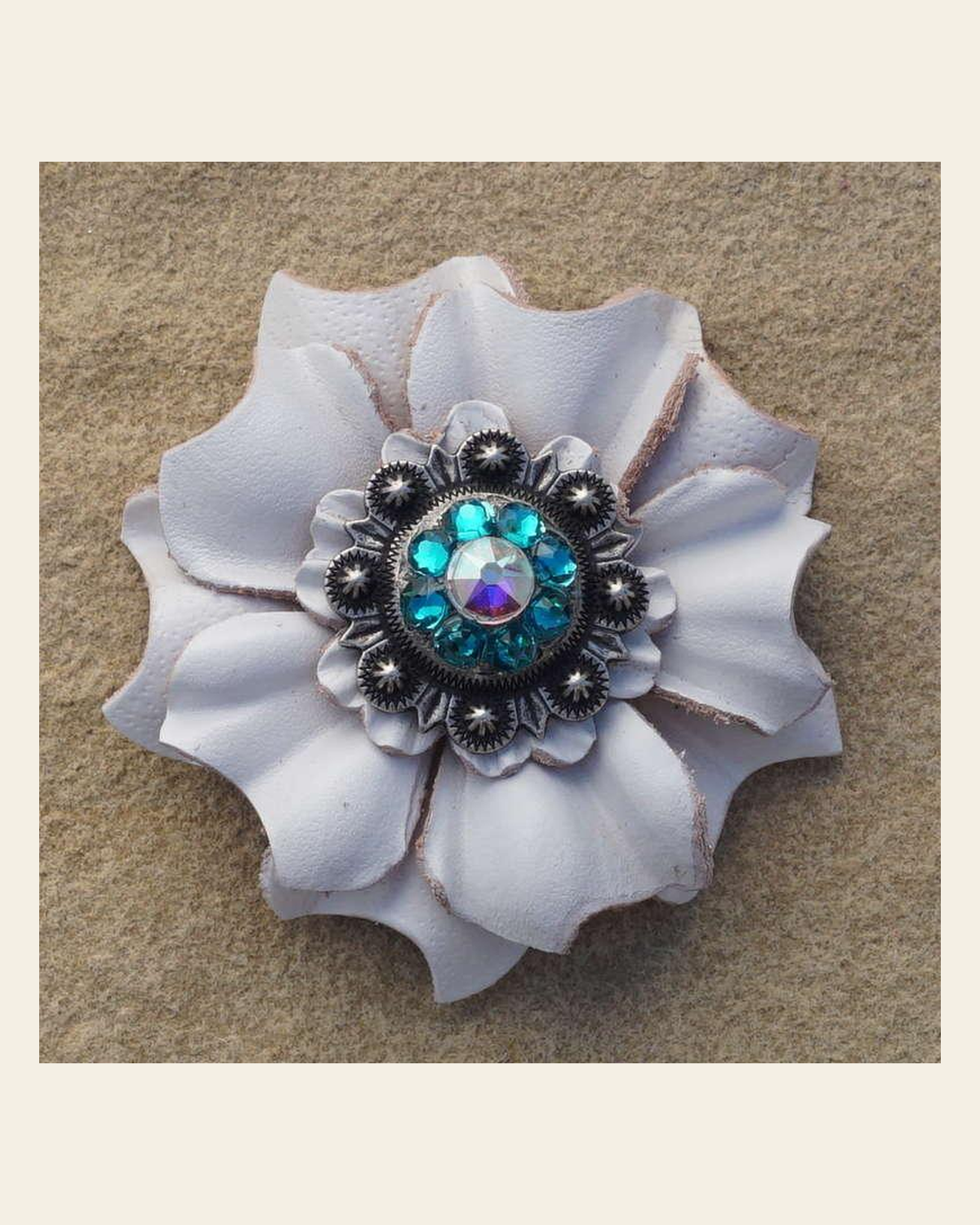 White Carnation Flower With Antique Silver Teal and AB 1" Concho on a warm cream background