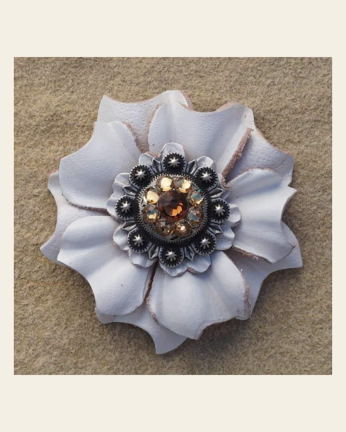 White Carnation Flower With Antique Silver Topaz & Champagne 1" Concho on a warm cream background