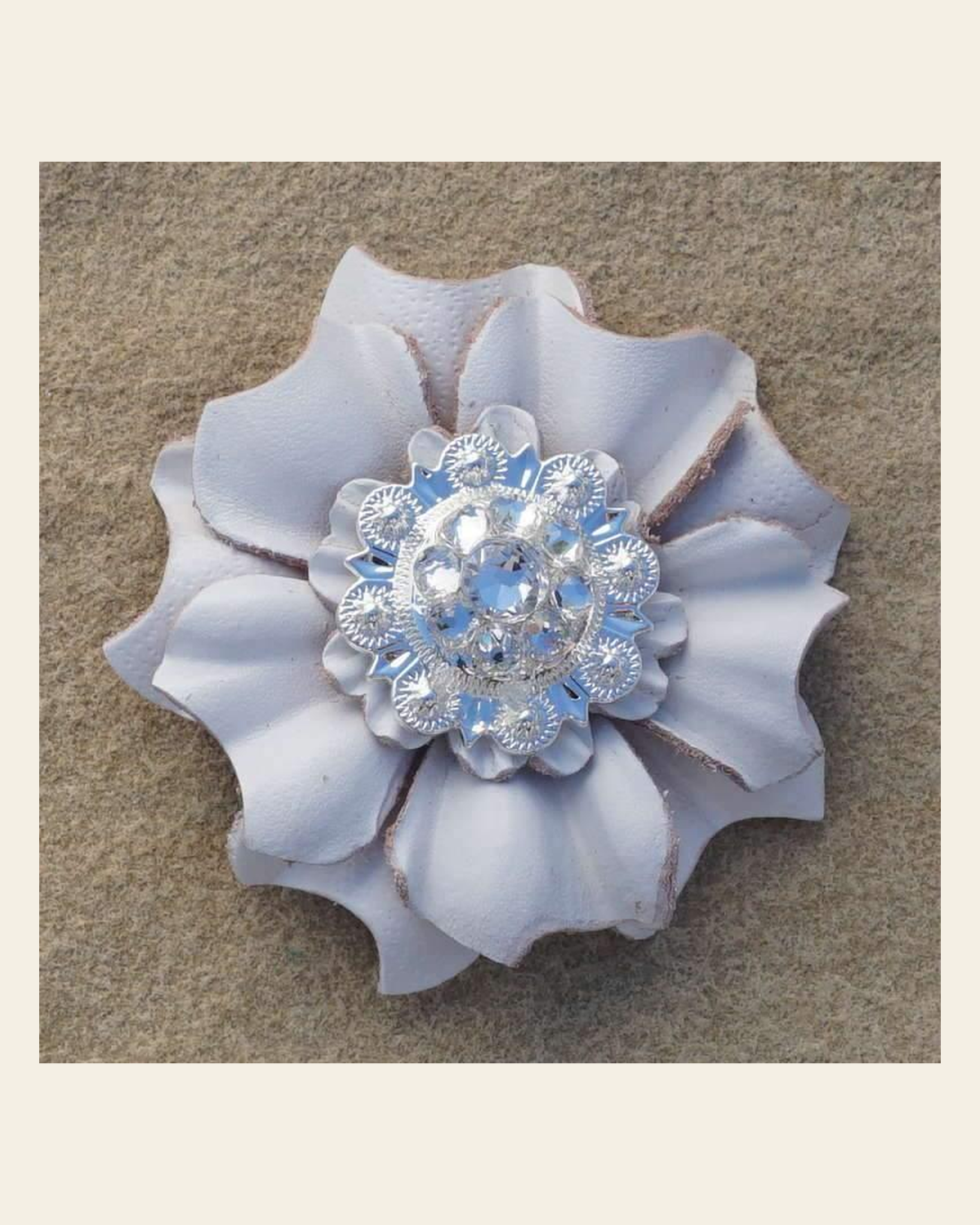 White Carnation Flower With Bright Silver Clear 1" Concho on a warm cream background