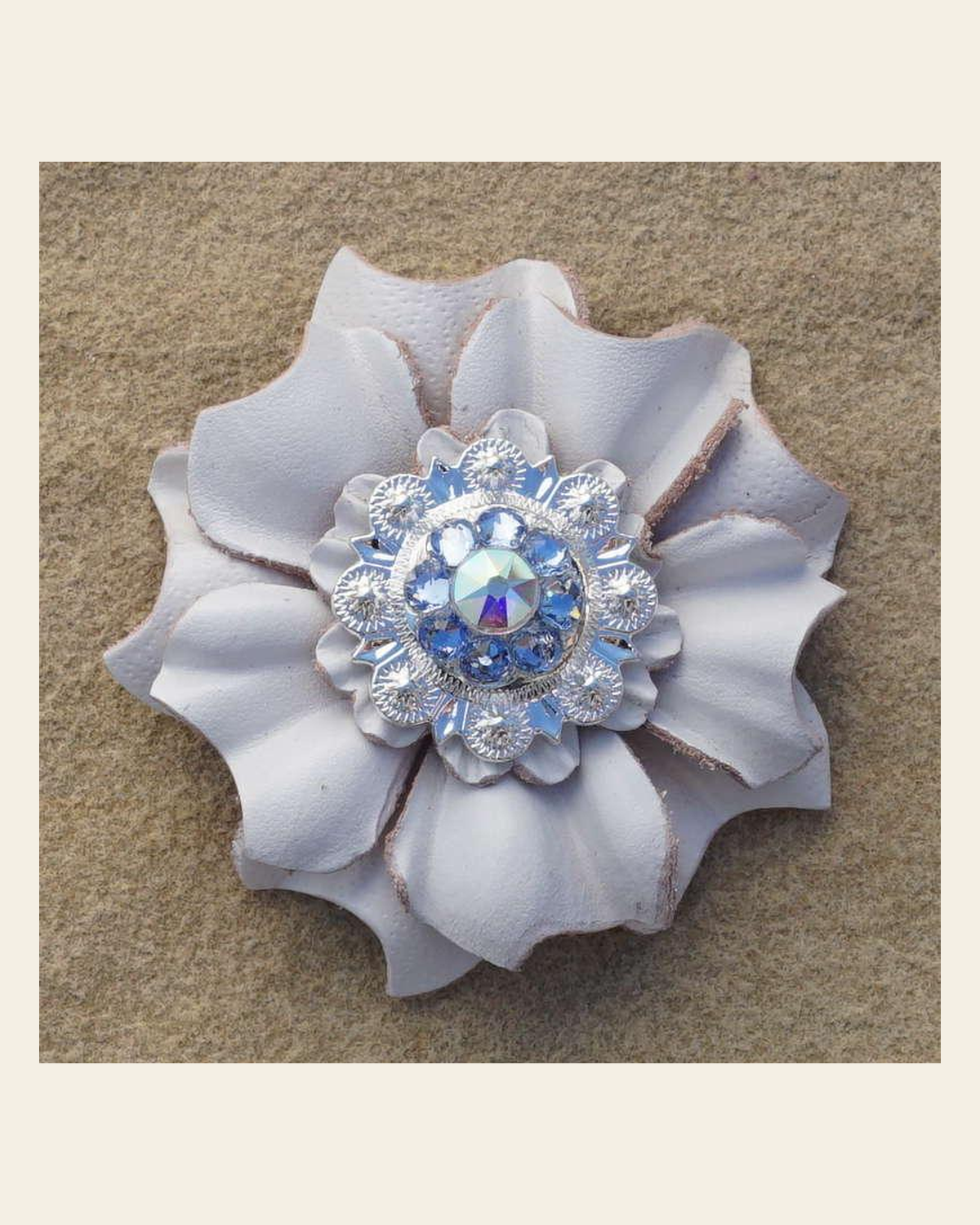 White Carnation Flower With Bright Silver Light Sapphire and AB 1" Concho on a warm cream background