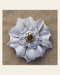 White Carnation Flower With Bright Silver Topaz & Champagne 1" Concho on a warm cream background