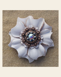 White Carnation Flower With Copper Jet and AB 1" Concho on a warm cream background