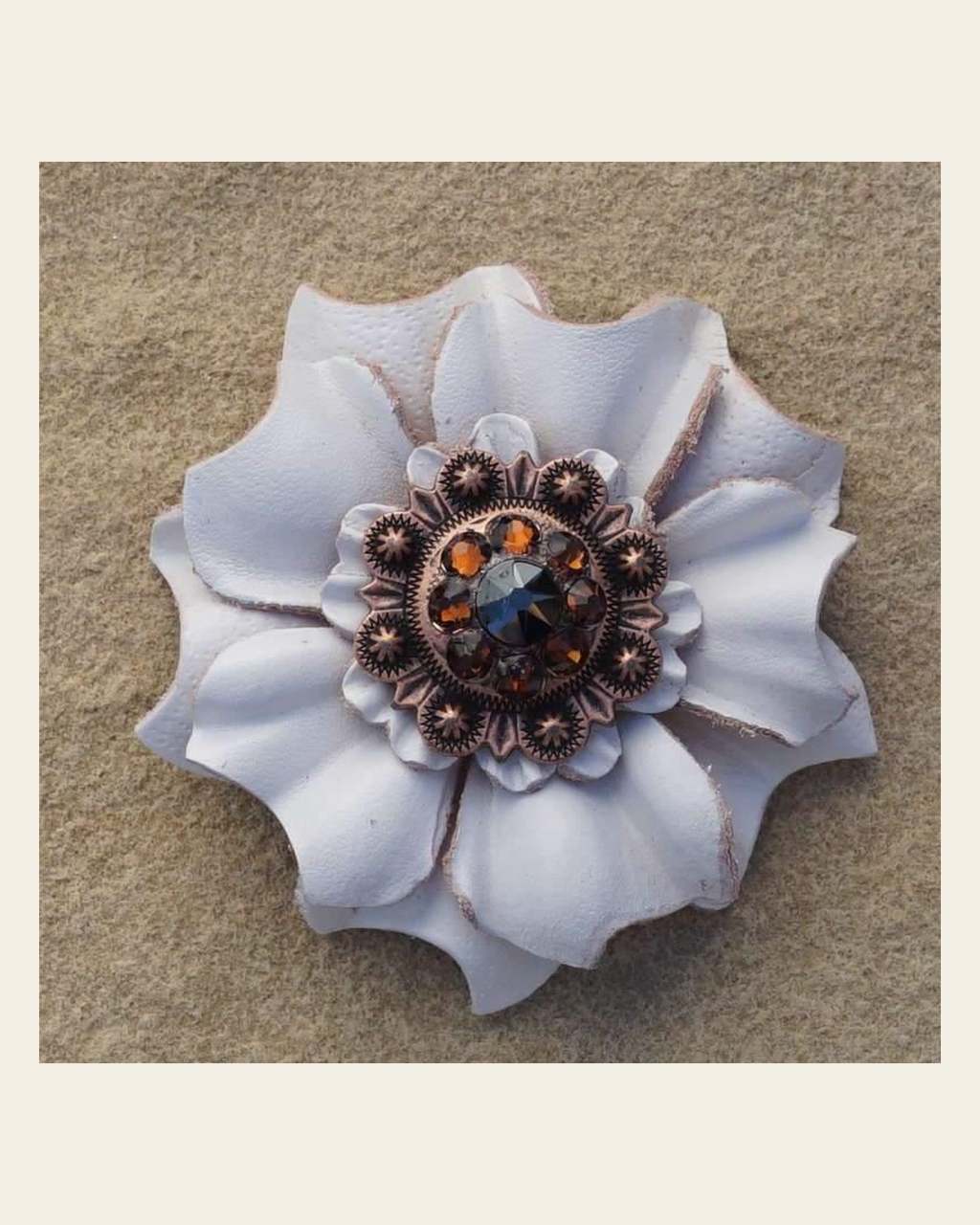 White Carnation Flower With Copper Jet & Topaz 1" Concho on a warm cream background