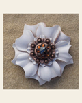 White Carnation Flower With Copper Jet & Topaz 1" Concho on a warm cream background
