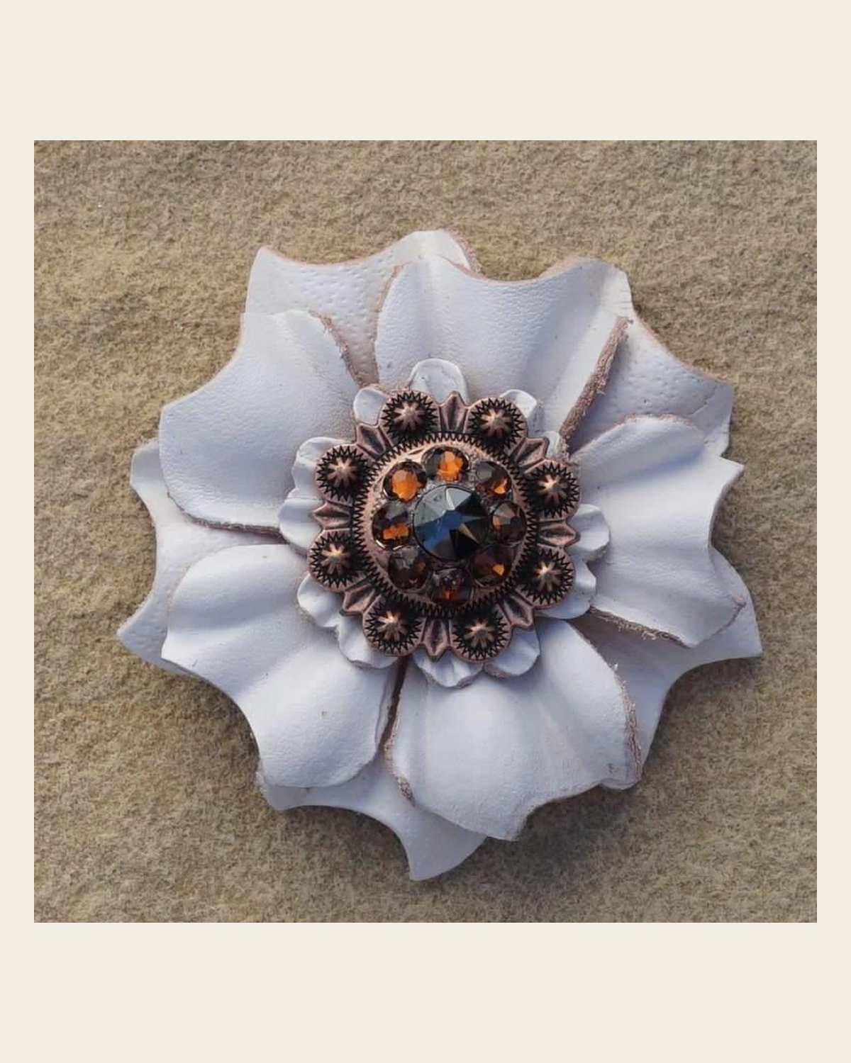 White Carnation Flower With Copper Jet & Topaz 1" Concho on a warm cream background