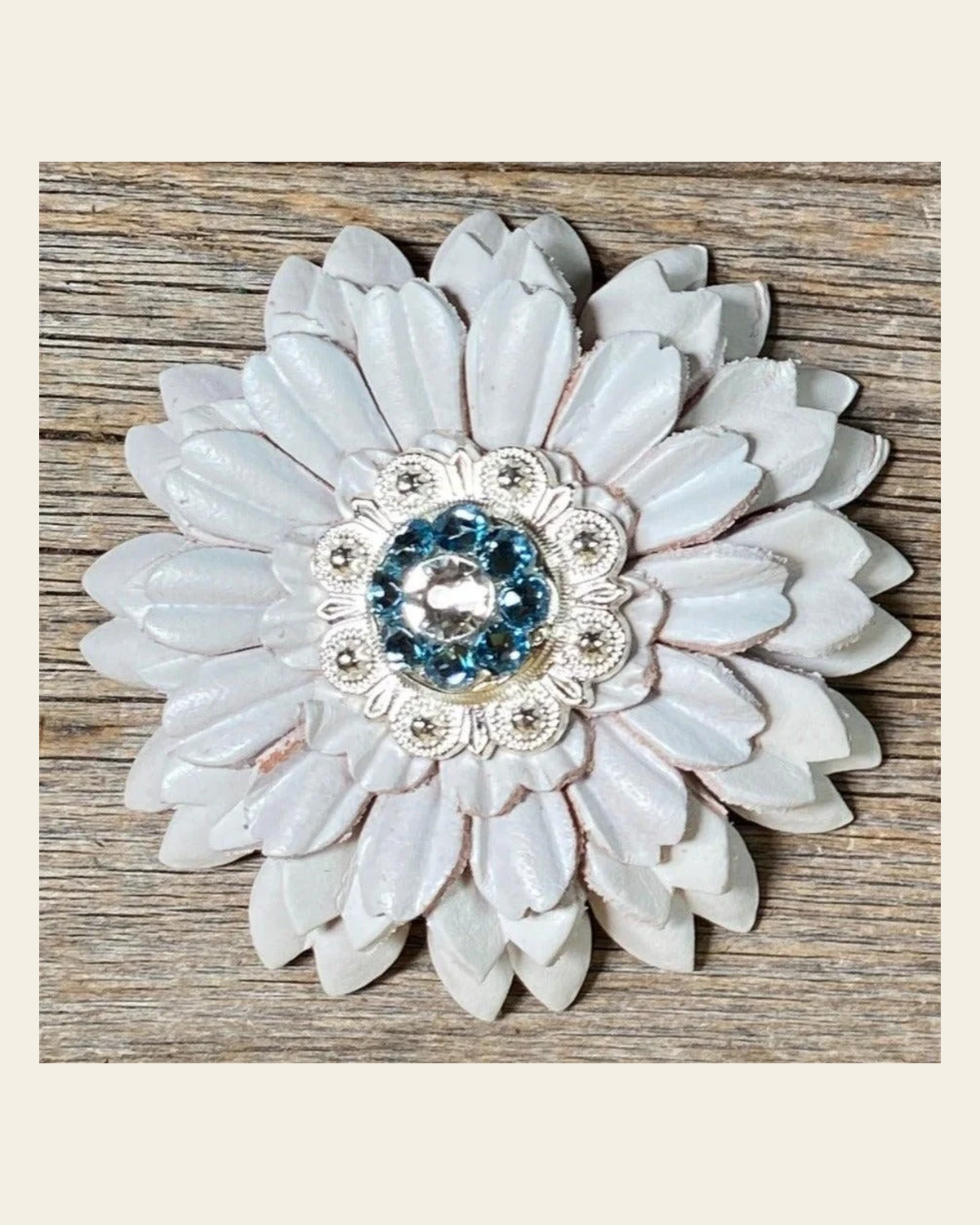 White Daisy Flower With Bright Silver Aqua & Clear 1" Concho on a warm cream background