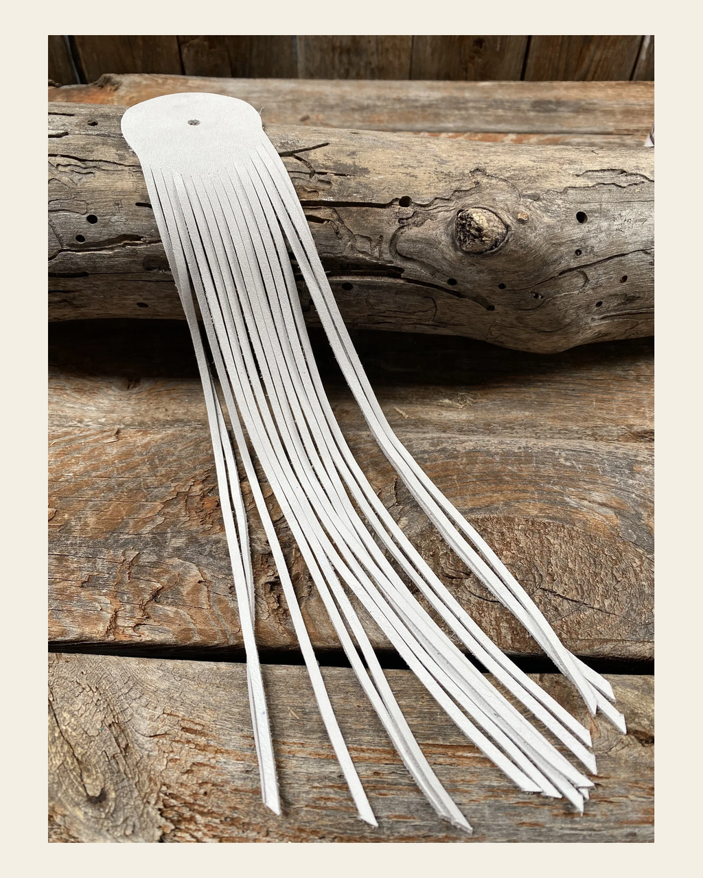 White Leather Fringe on a warm cream background