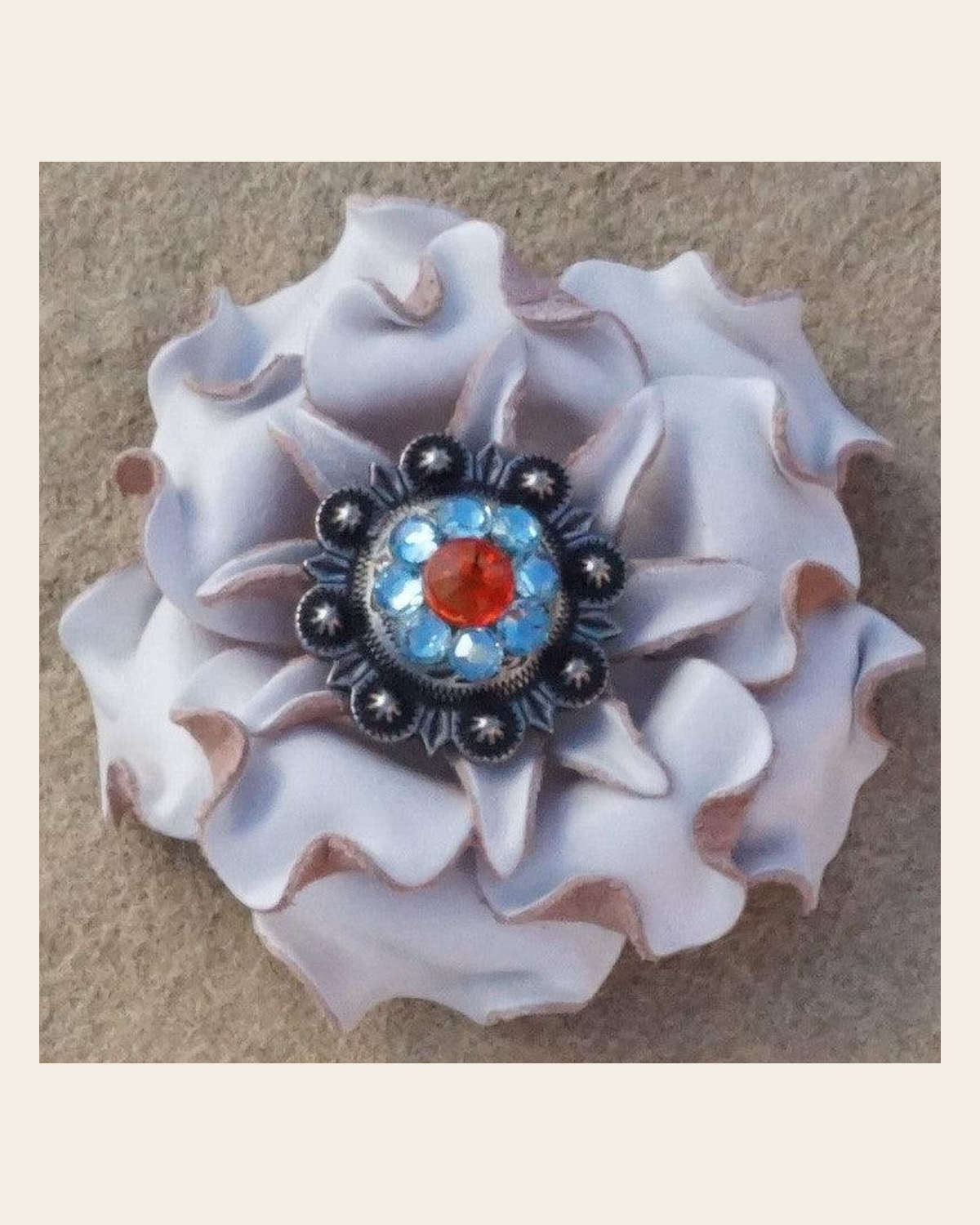 White Gardenia Flower With Antique Silver Fire Opal and Aqua 1" Concho on a warm cream background