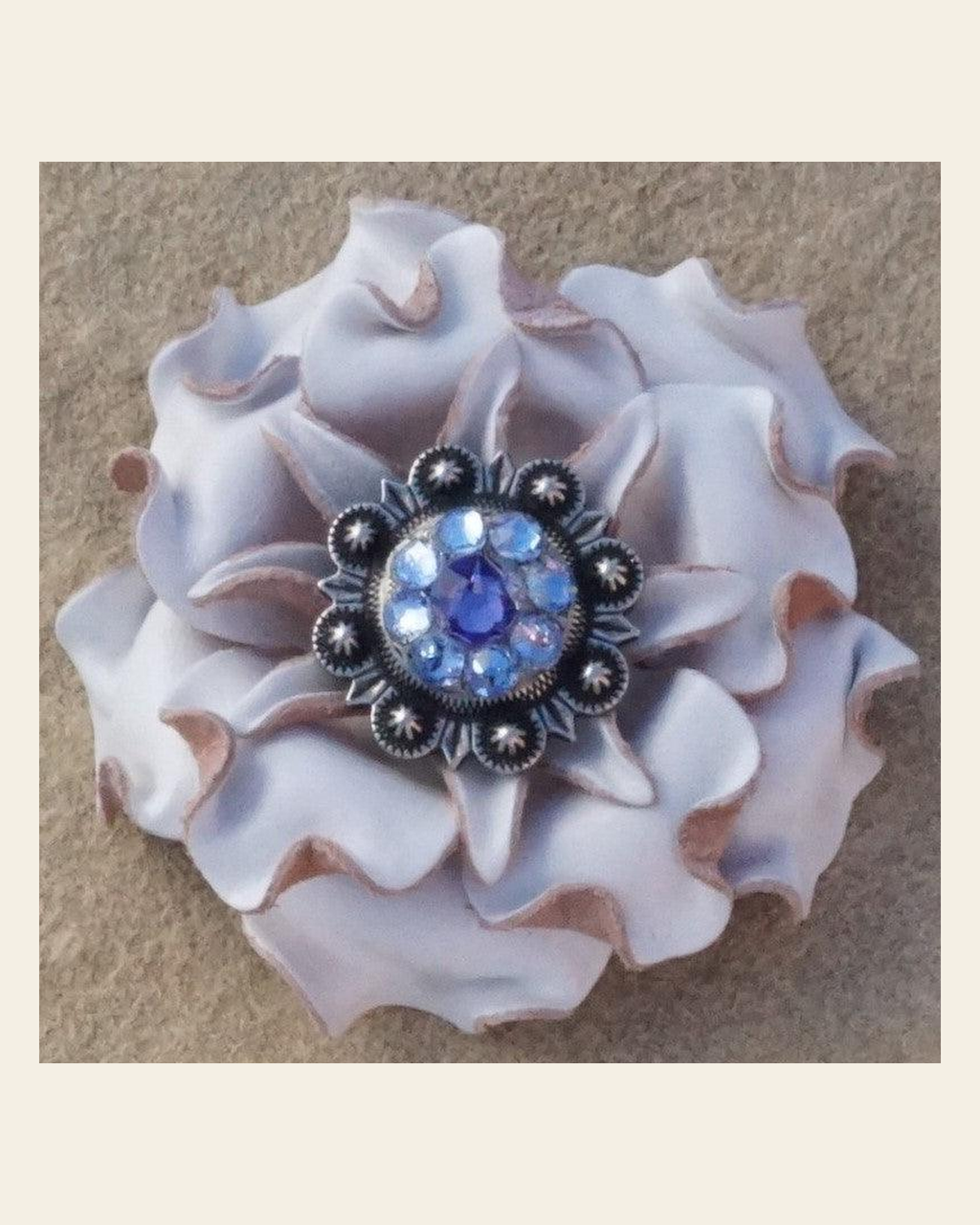 White Gardenia Flower With Antique Silver Lilac and Light Sapphire 1" Concho on a warm cream background