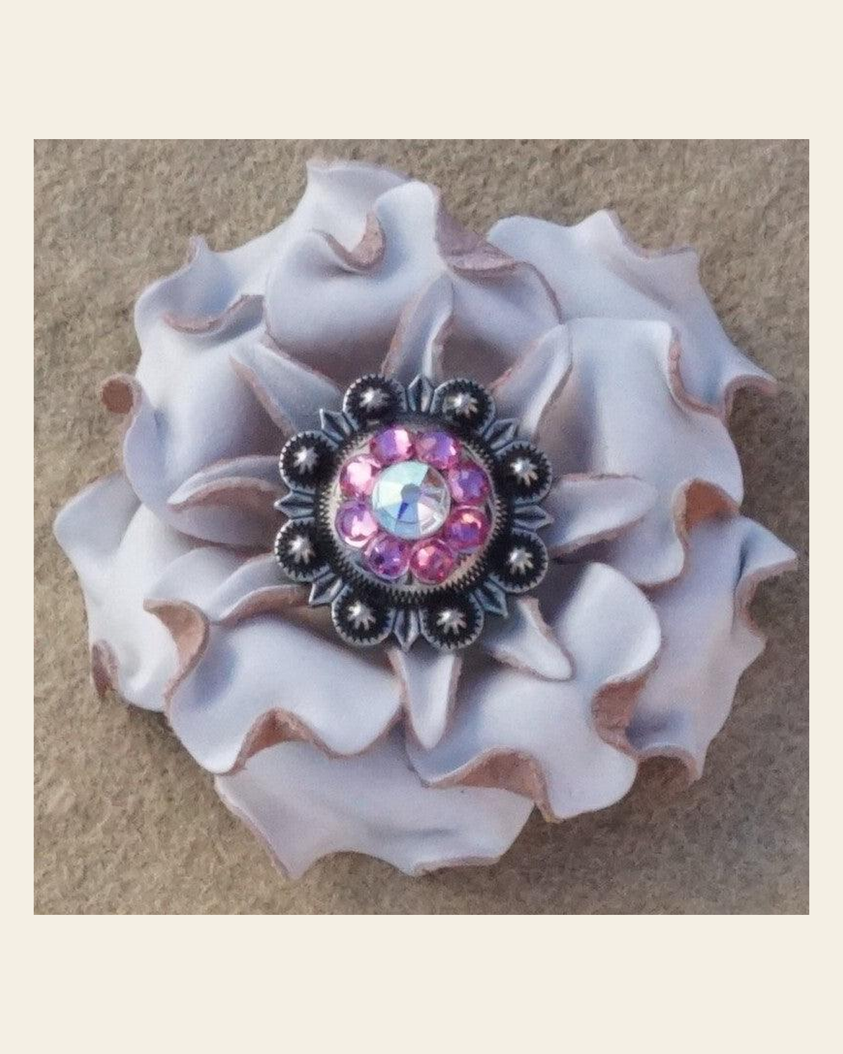 White Gardenia Flower With Antique Silver Pink and AB 1" Concho on a warm cream background