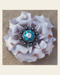 White Gardenia Flower With Antique Silver Teal and AB 1" Concho on a warm cream background