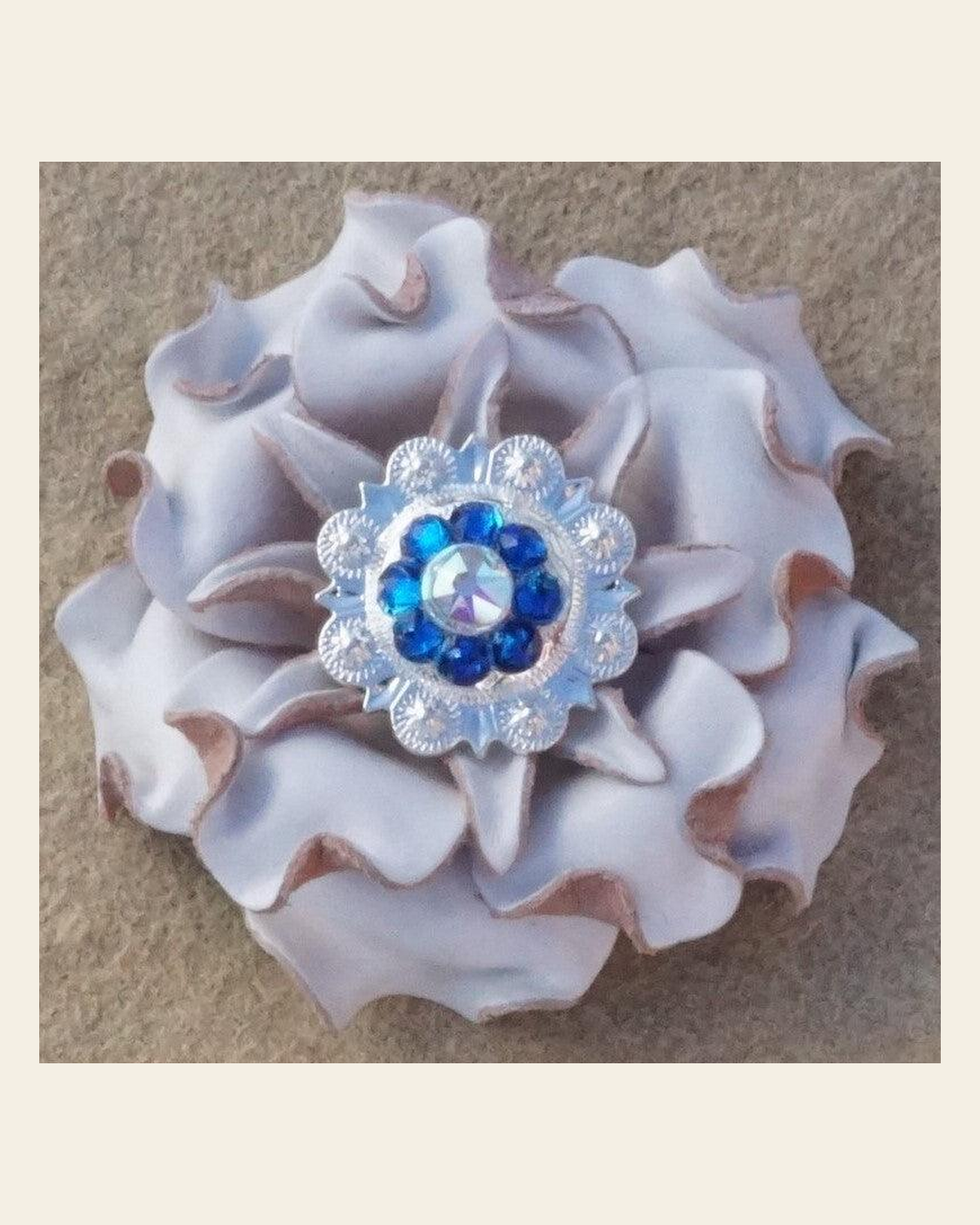 White Gardenia Flower With Bright Silver Capri and AB 1" Concho on a warm cream background